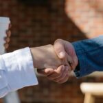 Close-up of a handshake between two adults, symbolizing agreement or partnership.